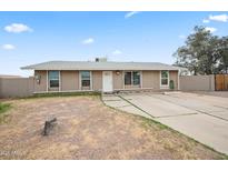 Charming single-story home featuring a well-maintained lawn and a welcoming facade at 907 N Menze St, Casa Grande, AZ 85122