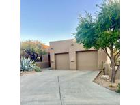 Southwest home with mature desert landscaping, and a two-car garage with a concrete driveway at 9110 E Clubhouse Ct # 639, Scottsdale, AZ 85262