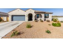 Charming single-story home with stucco exterior, desert landscaping, covered entryway, and attached two-car garage at 1060 W Castle Ct, Casa Grande, AZ 85122