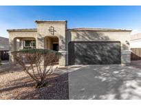 Charming home featuring a well-manicured yard and a two-car garage at 11230 E Cliffrose Ln, Florence, AZ 85132