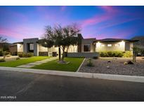 Stunning modern home featuring lush landscaping, desert rock accents and an eye-catching facade at 16908 S 31St Ln, Phoenix, AZ 85045