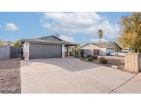 Single-story home with a spacious driveway and well-maintained landscaping at 2016 N Pennington Dr, Chandler, AZ 85224