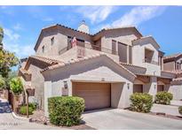 Charming two-story home with a private balcony and attached garage, surrounded by green landscaping at 3131 E Legacy Dr # 2105, Phoenix, AZ 85042