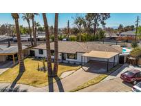 Charming single-story home with a covered carport and a well-maintained front yard at 3707 E Amelia Ave, Phoenix, AZ 85018