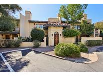 Inviting condo featuring lush landscaping, warm stucco and a charming front entrance with beautiful architectural details at 5825 N 12Th St # 3, Phoenix, AZ 85014