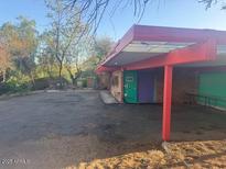 Charming house featuring a unique carport design and colorful doors at 6528 N Hillside Dr, Paradise Valley, AZ 85253