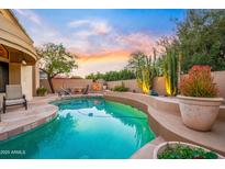 Inviting backyard oasis featuring a private pool, mature desert landscaping, and an outdoor dining area at 7705 E Doubletree Ranch Rd # 29, Scottsdale, AZ 85258