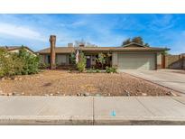 Charming single-story home featuring a well-maintained yard and a two-car garage at 947 N Saffron --, Mesa, AZ 85205