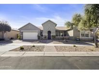 Charming single-story home with a well-manicured front yard and a two-car garage in a suburban neighborhood at 10049 E Topaz Ave, Mesa, AZ 85212