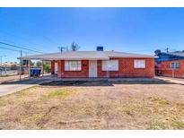Charming brick home featuring a covered carport and a well-maintained front yard at 1007 W 5Th St, Mesa, AZ 85201