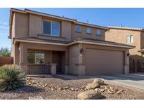 Charming two-story home with a cozy front porch, low-maintenance desert landscaping, and an attached two-car garage at 1329 W Crape Rd, Queen Creek, AZ 85140