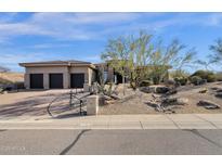 Charming single-story home features a three-car garage and desert landscaping at 13827 N Sunset Dr, Fountain Hills, AZ 85268