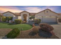 Charming single-story home featuring manicured landscaping and a spacious two-car garage at 14955 N 78Th Dr, Peoria, AZ 85381