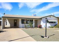 Charming single-story home featuring a well-maintained front yard and covered parking at 1510 S Lawther Dr, Apache Junction, AZ 85120