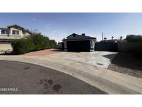 Charming single-Gathering home with a black garage door and a well-maintained front yard at 18829 N 15Th Pl, Phoenix, AZ 85024