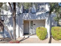 Inviting condo front entrance features a neutral color scheme, shaded entrance, and decorative balcony railing at 295 N Rural Rd # 273, Chandler, AZ 85226