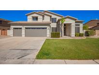 Charming two-story home featuring a well-maintained lawn, mature landscaping, and a spacious three-car garage at 3730 E Diamond Ct, Gilbert, AZ 85297