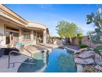 Beautiful backyard pool and patio area, perfect for outdoor entertaining and relaxation at 42047 N Moss Springs Rd, Anthem, AZ 85086