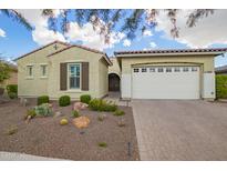 Charming single-story home featuring a two-car garage and desert landscaping at 5189 N 206Th Dr, Buckeye, AZ 85396