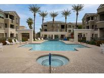 Community pool and lounge area surrounded by palm trees offering a relaxing outdoor retreat at 5303 N 7Th St # 101, Phoenix, AZ 85014
