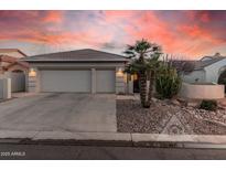 Charming single-story home featuring a tile roof, desert landscaping, and a spacious three-car garage at 10031 E Nacoma Ct, Sun Lakes, AZ 85248