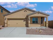 Inviting single-story home featuring a neutral color scheme, well-kept landscaping, and an attached two-car garage at 10281 N 115Th Ave, Youngtown, AZ 85363