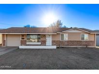Charming single-story home with a brick accent and a well-lit facade at 12211 N 25Th Ave, Phoenix, AZ 85029