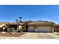 Charming single-story home with a well-maintained yard, desert landscaping, and two-car garage at 1339 N Tucana Ln, Gilbert, AZ 85234
