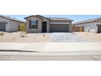 Charming single-story home with gray stucco and a well-manicured, xeriscaped front yard at 1661 N St Francis Pl, Casa Grande, AZ 85122