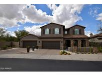 Inviting two-story home boasting a three-car garage and desert landscaping at 17594 N 98Th Way, Scottsdale, AZ 85255