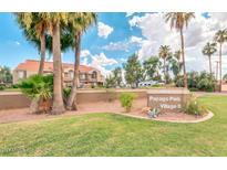 Papago Park Village II community entrance with lush landscaping, palm trees and building view at 1905 E University Dr # 162, Tempe, AZ 85288