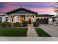 Beautiful single-story home featuring a landscaped front yard and a covered porch with stone accents at 20584 W Hillcrest Blvd, Buckeye, AZ 85396