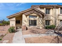 Charming townhome with a well-manicured front yard, complemented by a quaint brick fence and walkway at 2201 N Comanche Dr # 1080, Chandler, AZ 85224