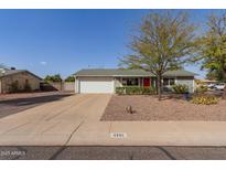 Charming single-story home with a well-maintained front yard, desert landscaping, and a two-car garage at 3302 W Tonto Ln, Phoenix, AZ 85027