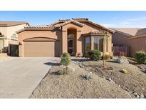 Single story home featuring a two car garage and desert landscaping at 3517 N Paseo Del Sol --, Mesa, AZ 85207