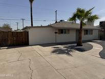 Charming single-story home featuring desert landscaping and a spacious concrete driveway at 3807 N 64Th Dr, Phoenix, AZ 85033