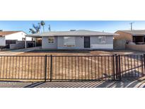 Charming single story home with grey exterior, landscaped yard, and black metal fence at 3821 W Verde Ln, Phoenix, AZ 85019