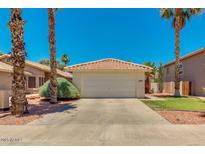 Charming single-story home featuring a desert landscape, a two-car garage, and terra cotta tile roof at 4330 E Desert Trumpet Rd, Phoenix, AZ 85044