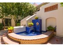 Beautiful courtyard fountain with brick and blue tile accents, surrounded by lush greenery at 5200 S Lakeshore Dr # 106, Tempe, AZ 85283