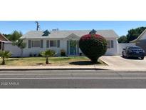 Charming single-story home with vibrant bougainvillea and well-maintained front yard at 6607 W Osborn Rd, Phoenix, AZ 85033