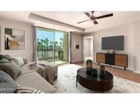 Inviting living room boasts a sliding glass door, ceiling fan, and modern furniture at 6803 E Main St # 3306, Scottsdale, AZ 85251