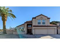 Charming two-story home with a well-manicured yard, a grand entrance and a three car garage at 6901 W Marco Polo Rd, Glendale, AZ 85308