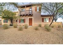 Inviting two-story home featuring a charming balcony and desert landscaping at 10421 W Via Del Sol -- # 379, Peoria, AZ 85383
