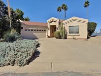 Single story home featuring a well-manicured yard, neutral colors, and desert landscaping at 15720 S Lanai Cir, Arizona City, AZ 85123