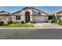 Charming single-story home with stucco siding, arched entryway, and well-manicured lawn at 17064 N Willow Path, Surprise, AZ 85374