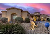 Stunning exterior showcasing desert landscaping and a charming home design under a beautiful twilight sky at 1808 W Magdalena Ln, Phoenix, AZ 85041