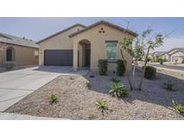 Charming single-story home featuring a low-maintenance desert landscape and inviting front entrance at 19437 W Elm St, Litchfield Park, AZ 85340