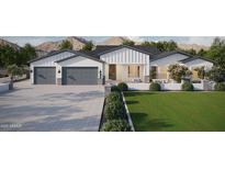 Stunning exterior of a modern farmhouse-style home with a three-car garage and beautiful landscaping at 20255 W Highland Ave, Litchfield Park, AZ 85340