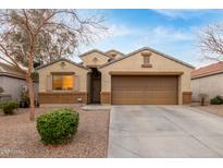 Charming single-story home featuring a two-car garage, gravel landscaping, and a neutral color palette at 2110 S 102Nd Ln, Tolleson, AZ 85353