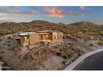 Expansive desert home featuring a modern design with stacked stone accents and ample privacy at 26885 N 87Th Dr, Peoria, AZ 85383